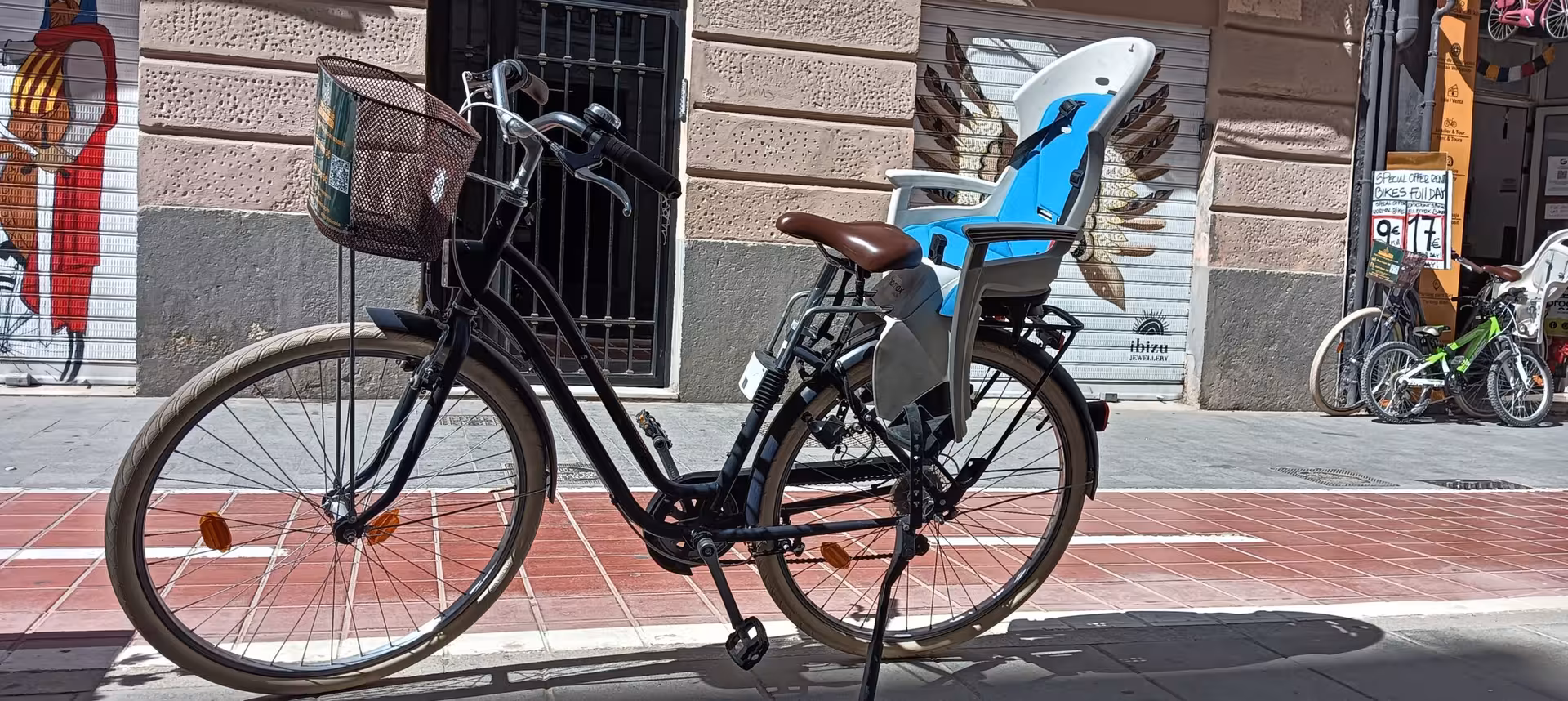Adult city bike rental with front basket and rear child seat, great for safe urban sightseeing and errands