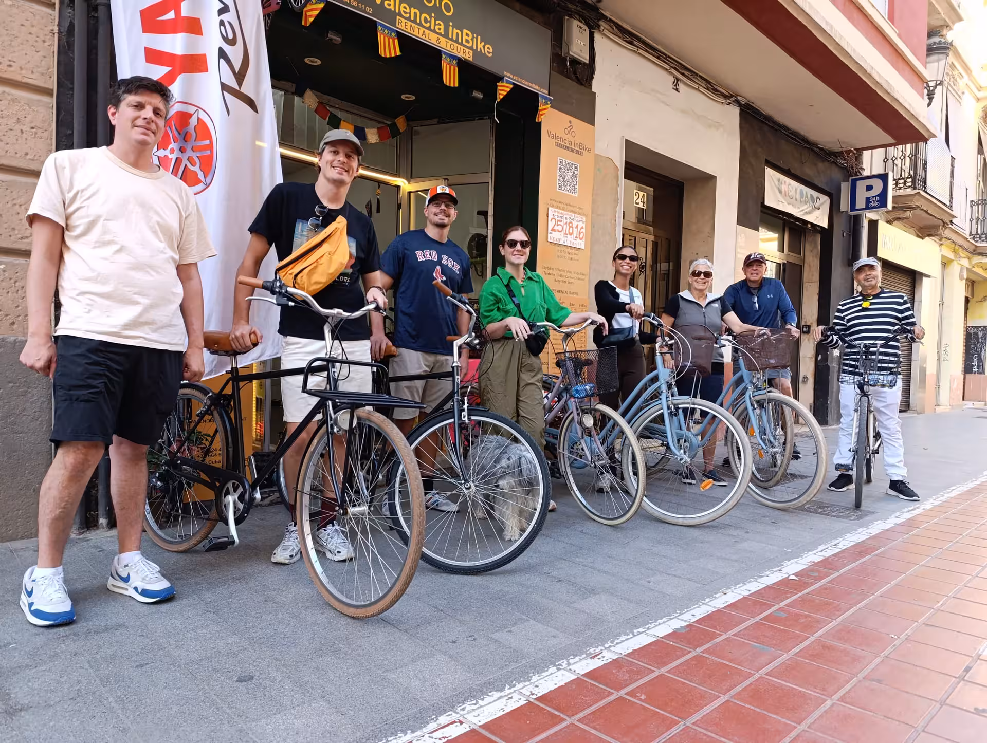 Large group with adult city bike rentals outside Valencia inBike shop, ideal for guided or self-guided tours
