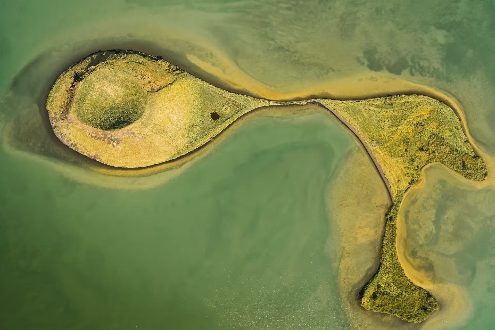 Aerial view of a green volcanic islet in Lake Mývatn, a highlight on the private North Iceland adventure tour