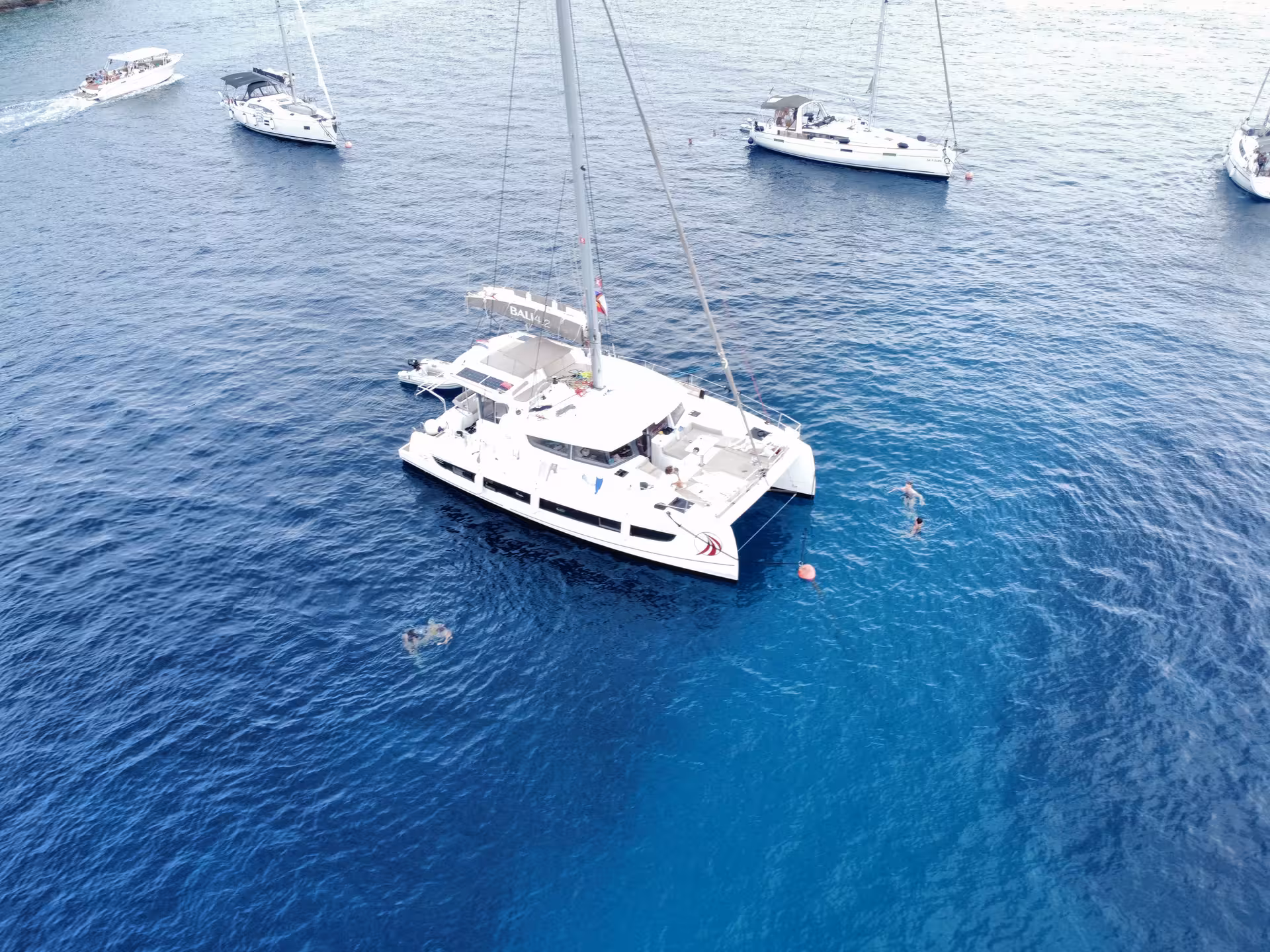 Aerial view of sailing catamaran on blue sea, ideal for multi-hull course training and liveaboard sailing lessons