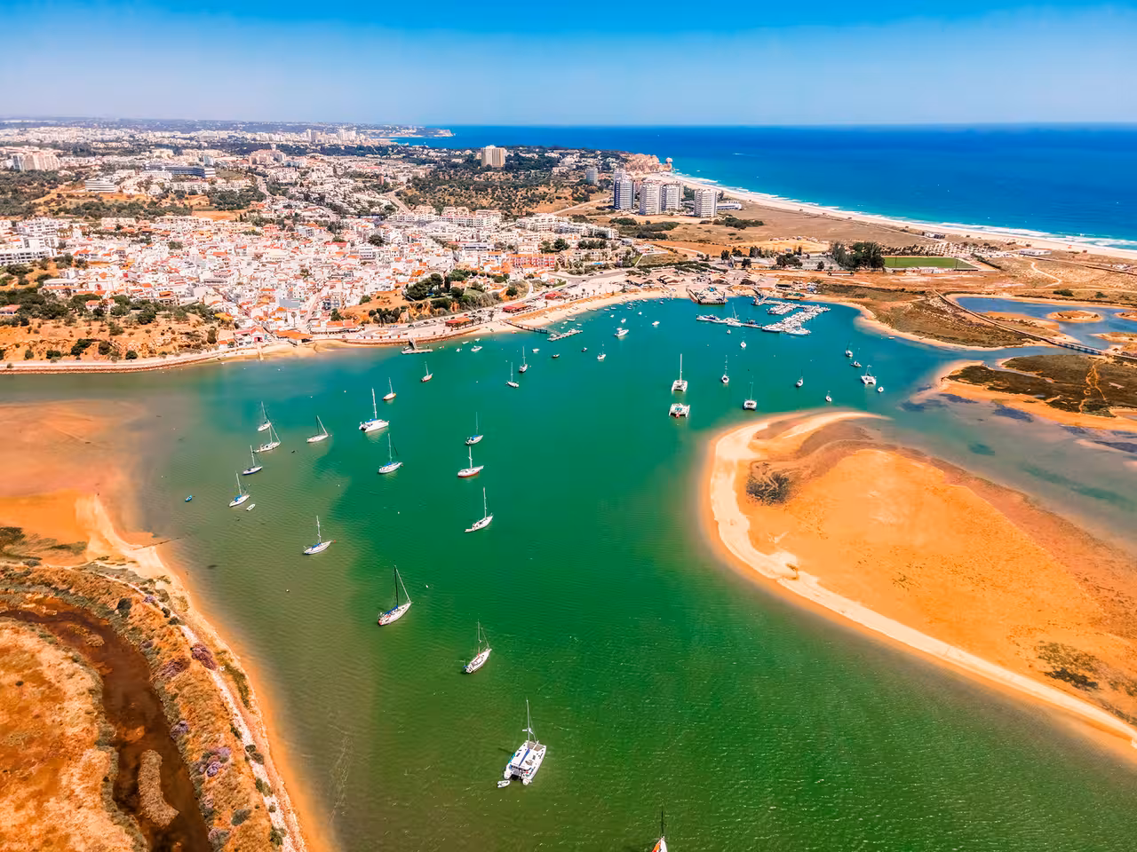 Aerial view of turquoise estuary and anchored yachts by sandy islands, Sailor for a Week coastal sailing trip