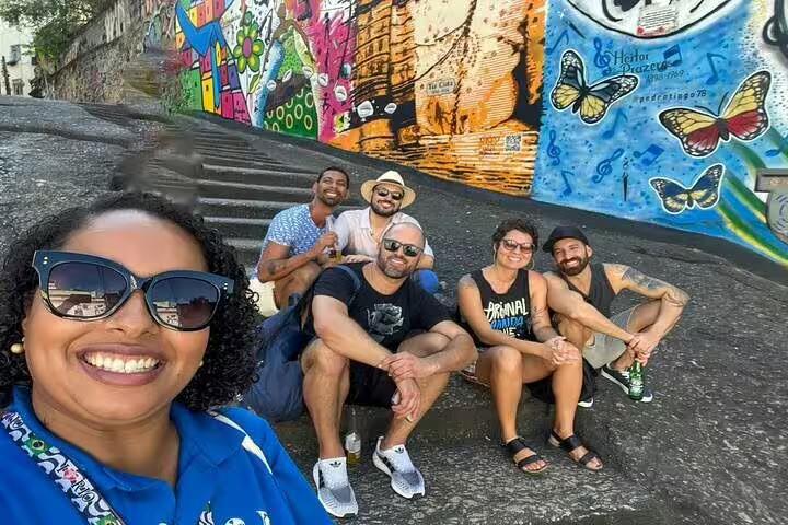 Group of tourists enjoying vibrant street art in Rio's Little Africa, highlighting Afro-Brazilian culture and heritage.