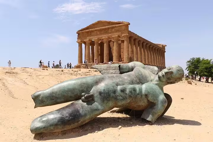 Ancient Greek temple and fallen bronze statue in Agrigento’s Valley of the Temples on a private tour from Palermo, Sicily