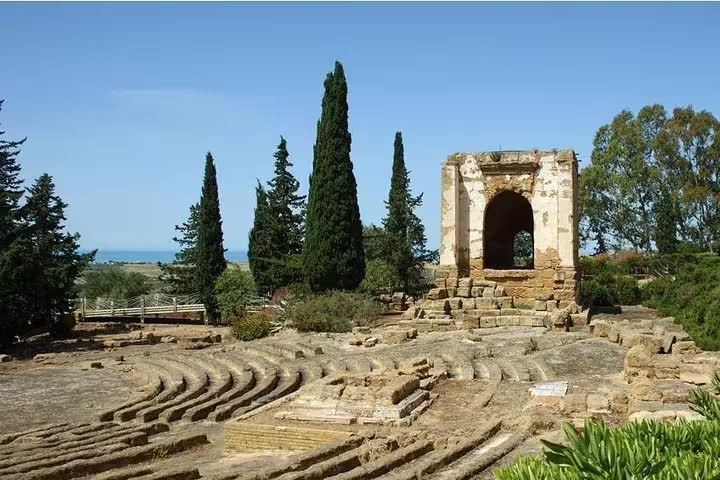 Ancient theatre ruins and stone archway at Agrigento Valley of the Temples on a private day trip from Palermo, Sicily