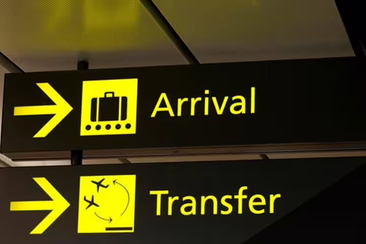 Yellow airport signs for arrivals and transfers, highlighting convenient travel options from Lisbon to Seville.