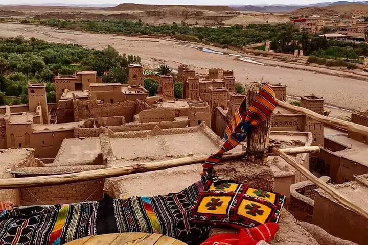 Ait Benhaddou kasbah rooftops and Berber carpets overlooking Ounila Valley on Morocco 12-day tour from Tangier