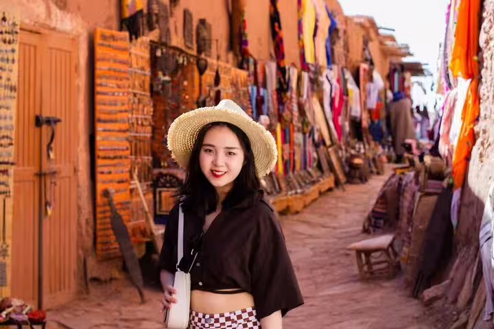 Traveler browsing Ait Benhaddou market street on Morocco 11 days tour from Casablanca via Sahara Desert