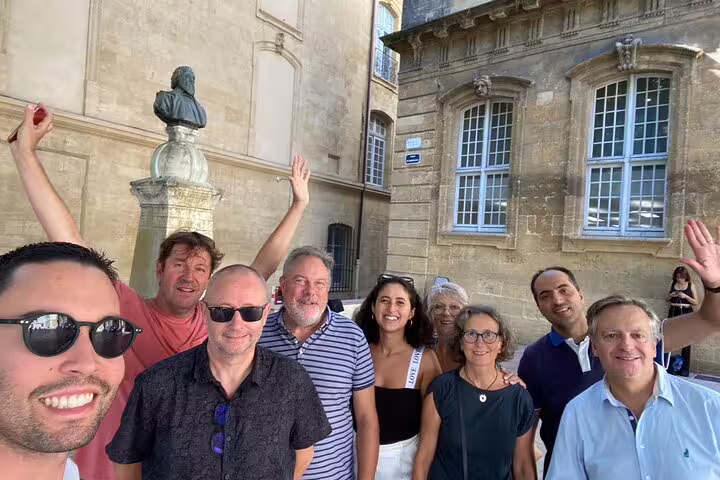Happy group selfie at a historic Aix-en-Provence square during a self-guided scavenger hunt walking tour