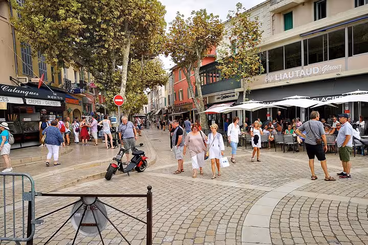 Lively Aix-en-Provence street square with cafes and shoppers during a full-day Aix Cassis Marseille tour