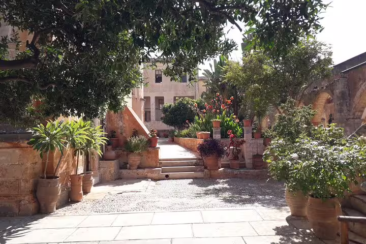 Lush garden pathway with vibrant plants and stone steps on the Akrotiri Peninsula hiking adventure.