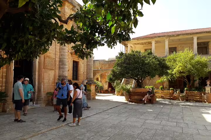 Visitors enjoy the serene atmosphere of a shaded courtyard on the Akrotiri Peninsula hiking tour.
