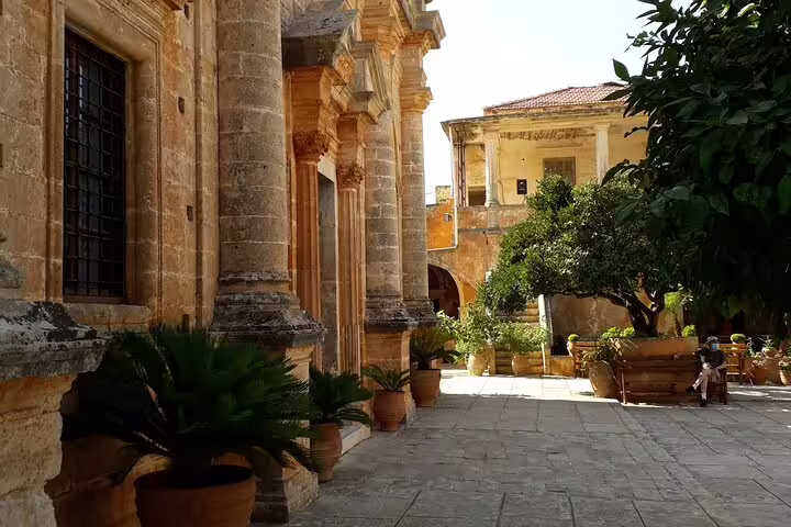 Historic stone structure with columns and vibrant plants on the Akrotiri Peninsula private hiking tour.