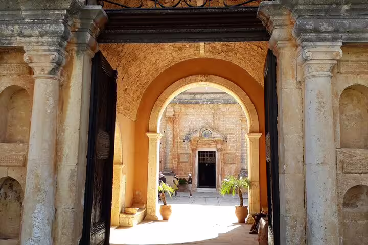 View through ancient stone archway leading to inner courtyard on Akrotiri Peninsula, perfect for hiking tour visitors.