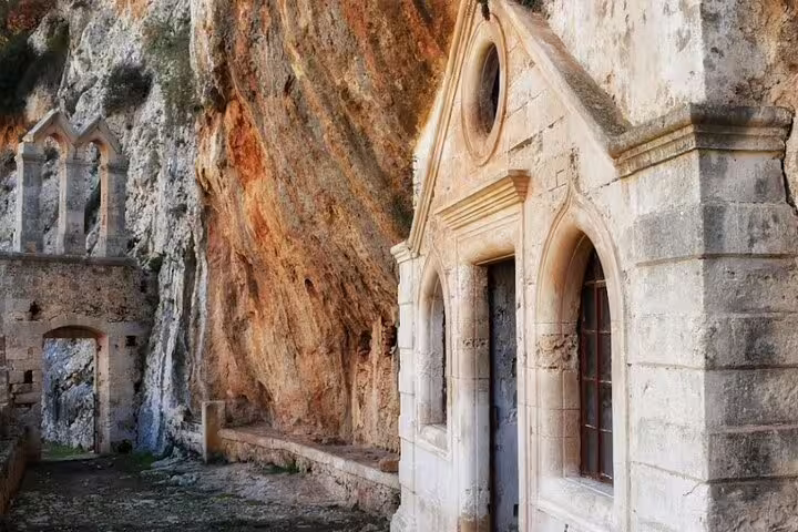 Historic stone chapel built into the rocky cliffs of the Akrotiri Peninsula, perfect for private hiking tours.