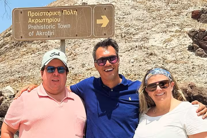 Guests at Akrotiri Prehistoric Town sign on Santorini, highlight of Island of Thera 8h tour with lunch and wine