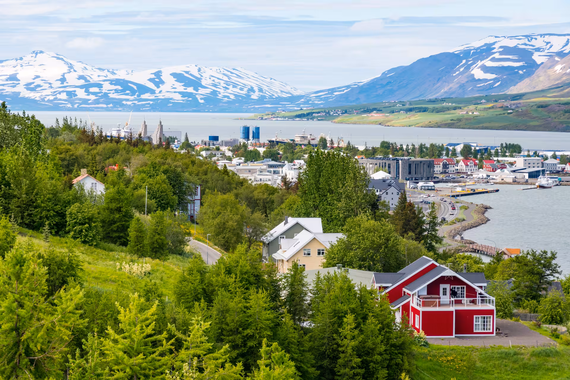 Scenic view of Akureyri town with snow-capped mountains and fjord, perfect for Iceland small group tours.