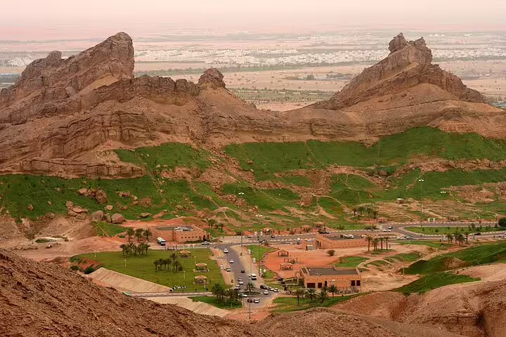 Stunning aerial view of Al Ain’s rocky landscape and green valleys on a private garden city tour.