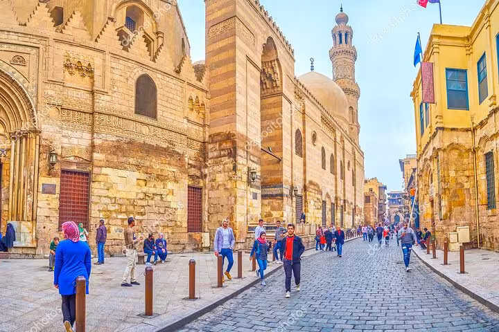 Al Azhar Mosque street in Islamic Cairo with minaret and pedestrians on VIP private tour route