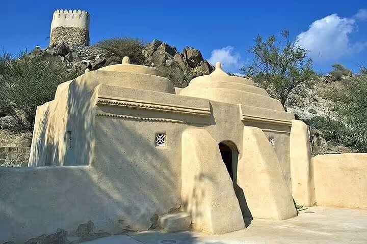 Historic Al Bidya Mosque nestled in rocky terrain, a must-see for Fujairah's heritage and architectural exploration.