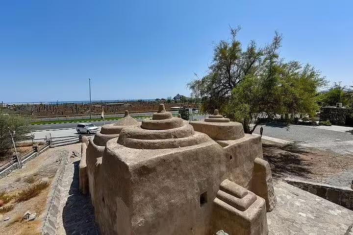 Al Bidya Mosque in Fujairah showcasing ancient Islamic architecture on a sunny day, perfect for cultural exploration.