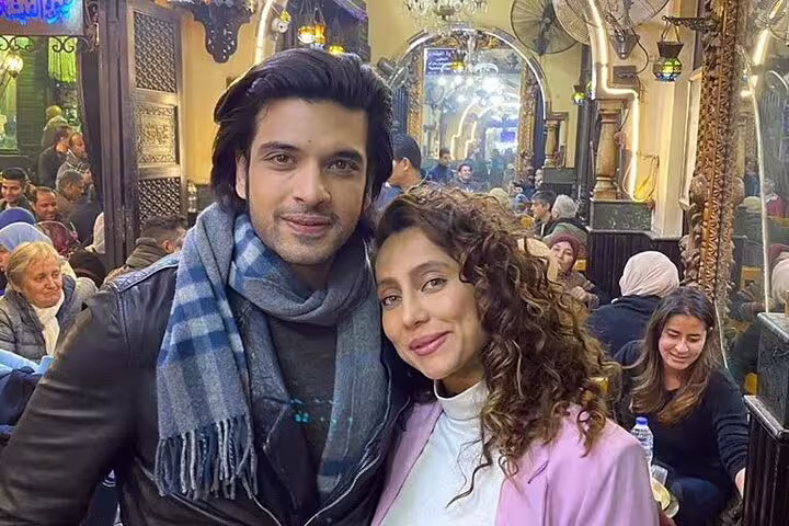 Visitors posing inside busy Al Fishawi café in Khan el-Khalili, highlight of Cairo by Night and Al Moez Street tour