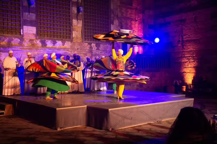 Al Tannoura Egyptian heritage dance troupe spinning in colorful skirts at Wekalet El Ghouri Cairo night show