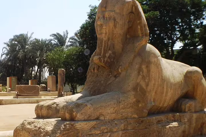 Alabaster Sphinx of Memphis in palm garden, highlight of Cairo layover tour to pyramids, Sakkara and Dahshur