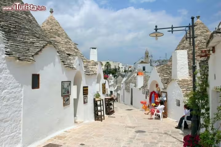 Guided walking tour through Alberobello’s UNESCO trulli district from Naples, with whitewashed lanes and conical stone roofs