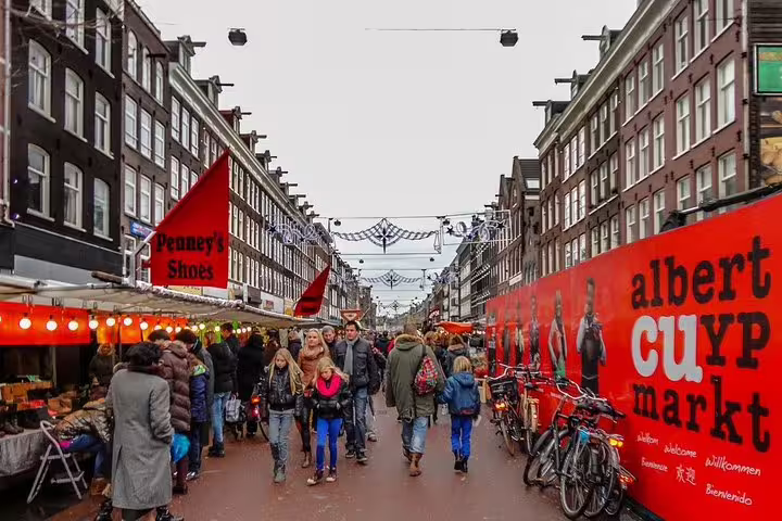 Bustling Albert Cuyp Market in Amsterdam, offering vibrant local culture and shopping on a private tour.