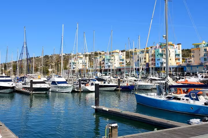 A vibrant marina in Albufeira with yachts and colorful buildings, perfect for exploring on a guided city walk.