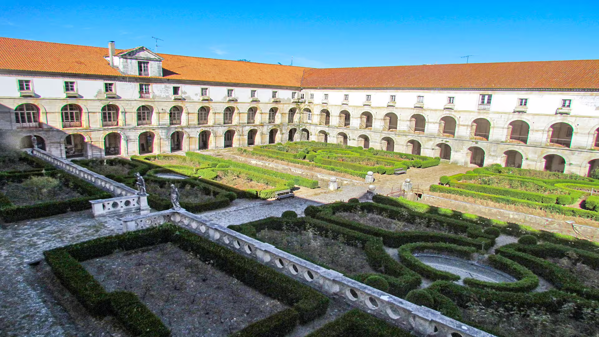 Explore the stunning courtyard of Alcobaça Monastery, a highlight of our private tour to Nazaré's giant waves and historical sites.