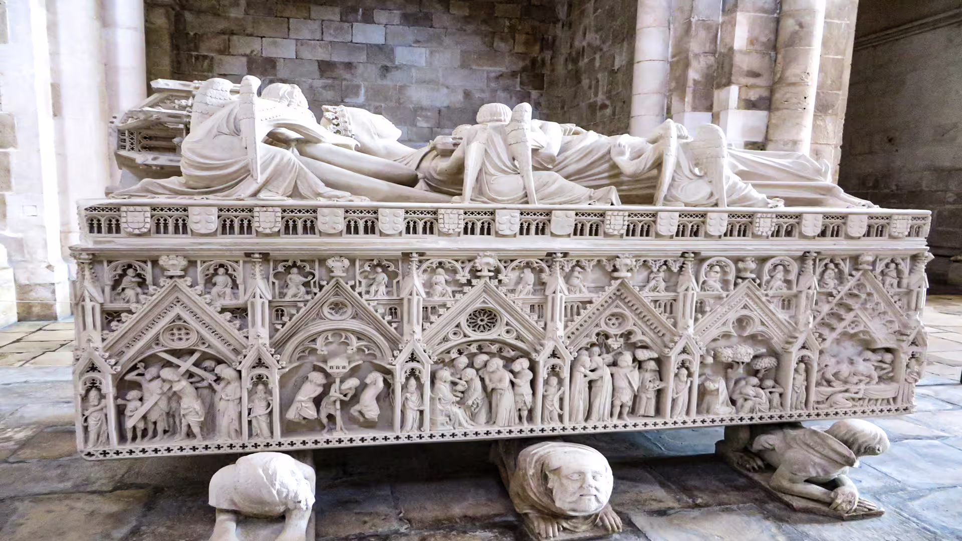 Ornate Gothic tomb in Alcobaça Monastery, showcasing intricate carvings and historic artistry on a private tour to Nazaré and Alcobaça.
