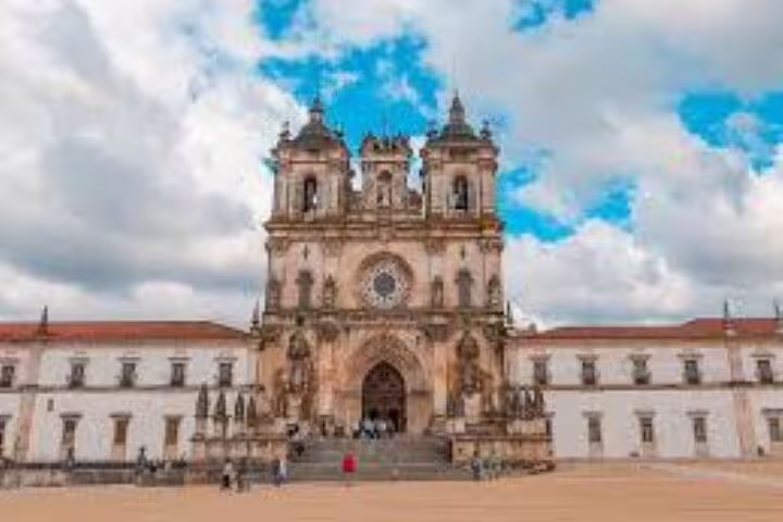 Explore the stunning facade of Alcobaça Monastery with its Gothic architecture on the Templars Route in Portugal.