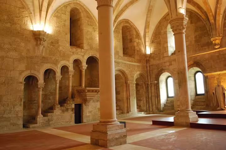 Explore the historic architecture of Alcobaça Monastery's grand interior on a private tour of Óbidos, Nazaré, and Alcobaça.