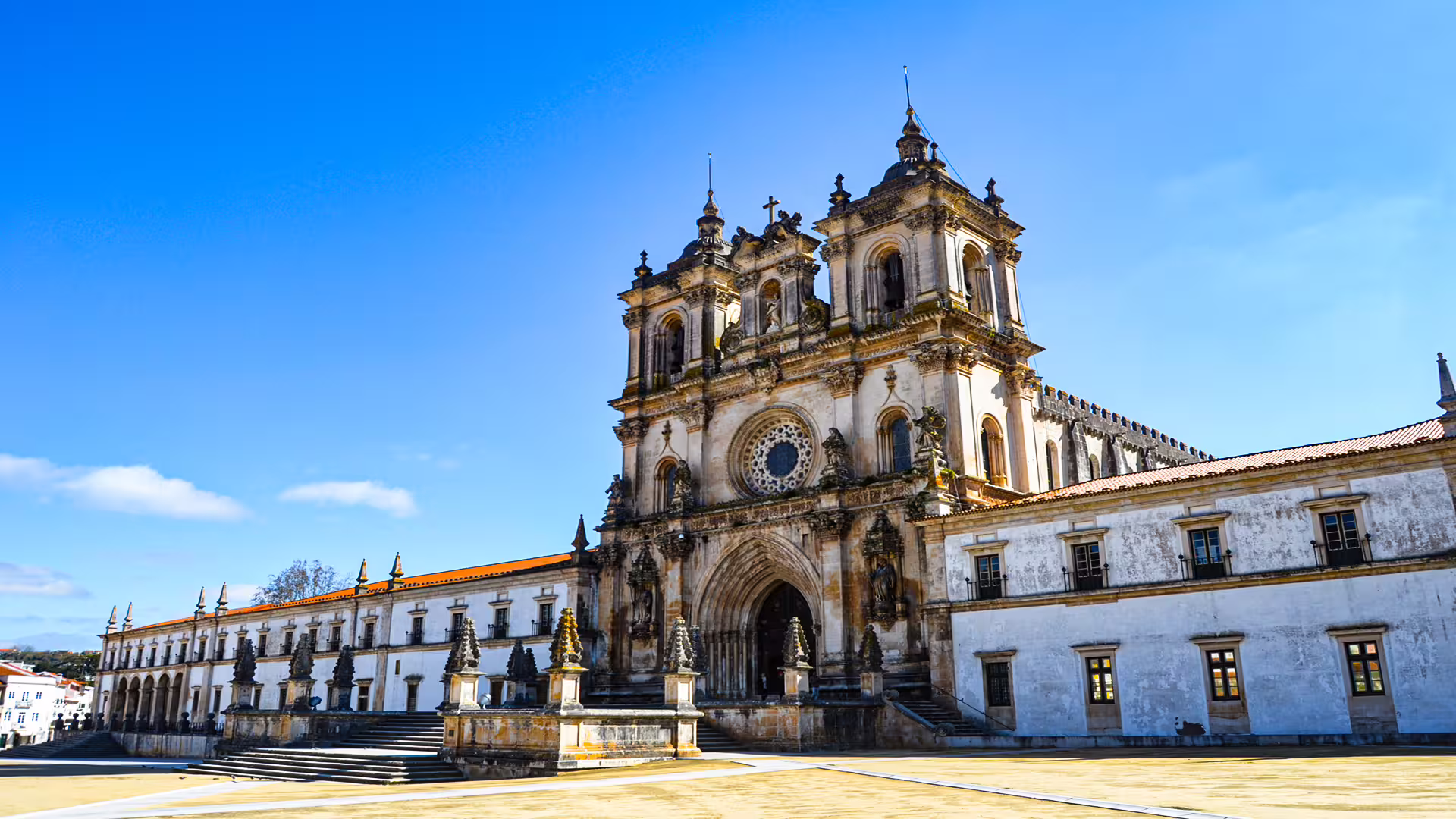 Alcobaça Monastery under a clear blue sky, a highlight of the private tour to Nazaré's giant waves and historic sites.