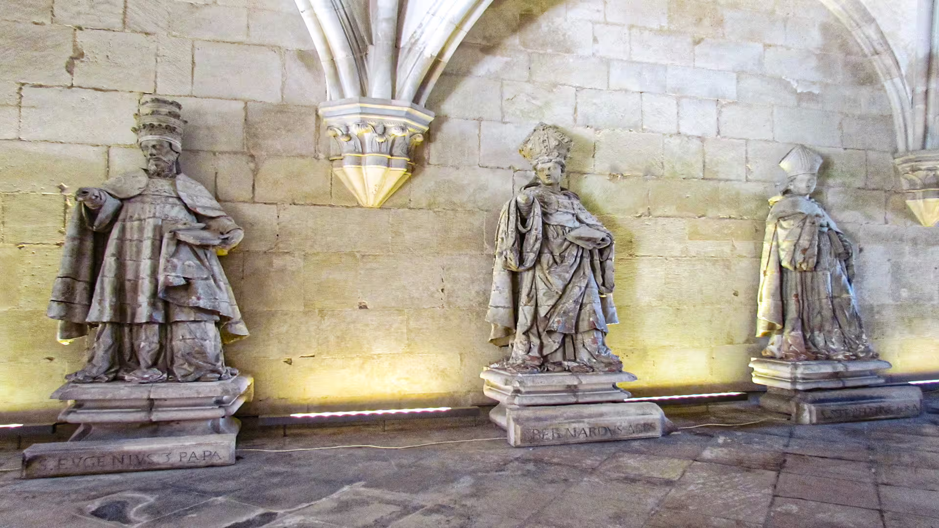 Ancient stone statues in Alcobaça Monastery, Portugal, showcasing historical figures on a private tour to Nazaré and Alcobaça.