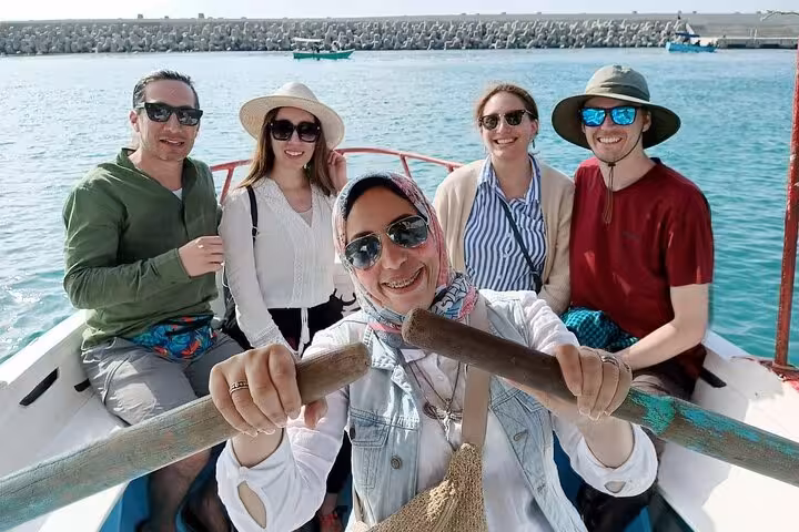 Travelers on boat in Alexandria harbor during private guided day tour from Cairo, Egypt sightseeing