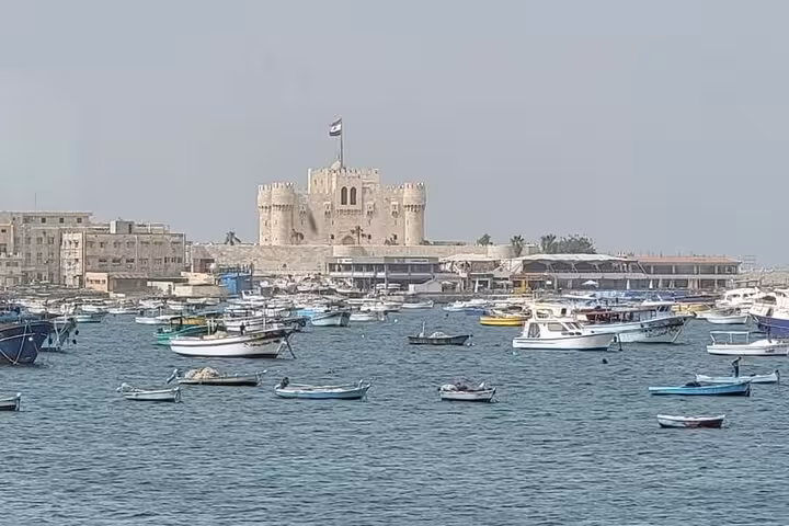 Alexandria harbor view with Qaitbay Citadel and fishing boats on a private guided day tour from Cairo