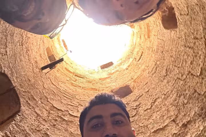 Travelers look up inside ancient stone well at Alexandria site on private VIP day tour with guide and lunch