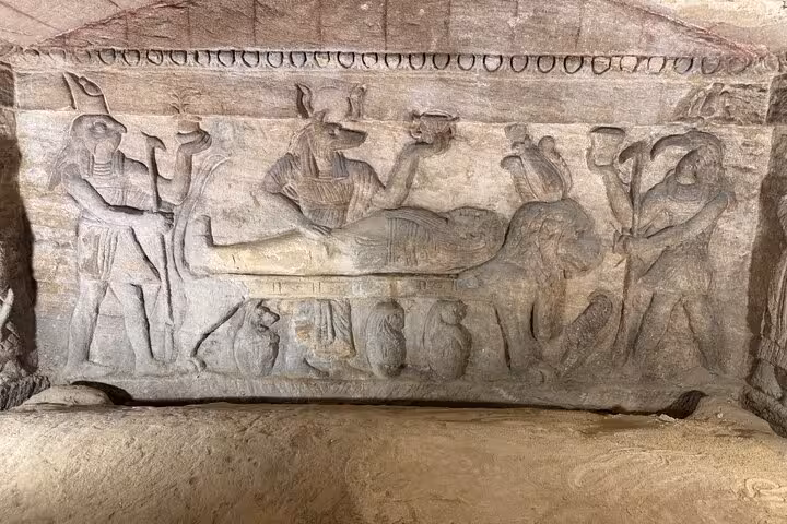 Carved funerary panel with Anubis and Egyptian deities at Kom El Shoqafa, Alexandria VIP guided tour