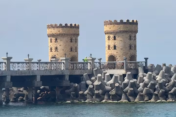 Alexandria VIP day tour stop at Qaitbay Citadel with twin towers and Mediterranean breakwater view