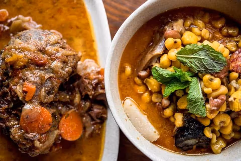 Traditional Algarve à la Carte stew with slow-cooked meat, beans and vegetables in rich sauce on a rustic Portuguese table