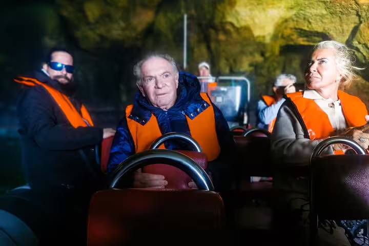 Traveler enjoys stunning coastal view near Algarve's Benagil caves during a private tour from Lisbon with boat trip.