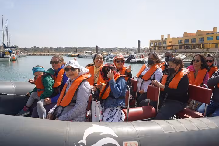Guests in life jackets on Algarve RIB boat trip from Lisbon, departing marina for Benagil Caves