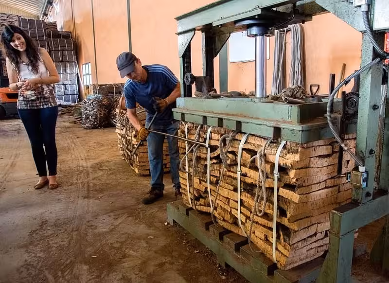 Visitor watches cork being pressed at a traditional Algarve cork factory, a highlight of Treasures of the Algarve tour
