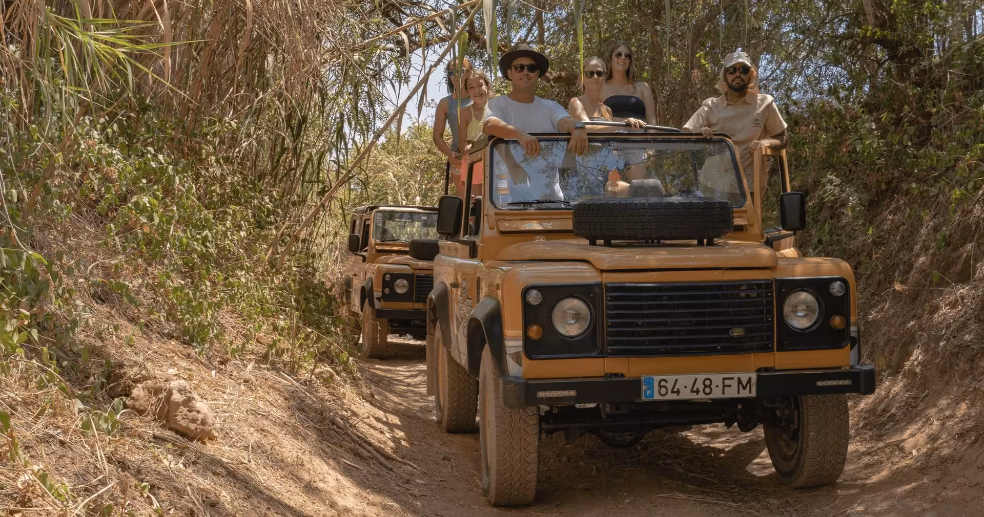 Guided jeep convoy driving through rustic Algarve trails with travelers enjoying The Algarve Heritage Journey adventure