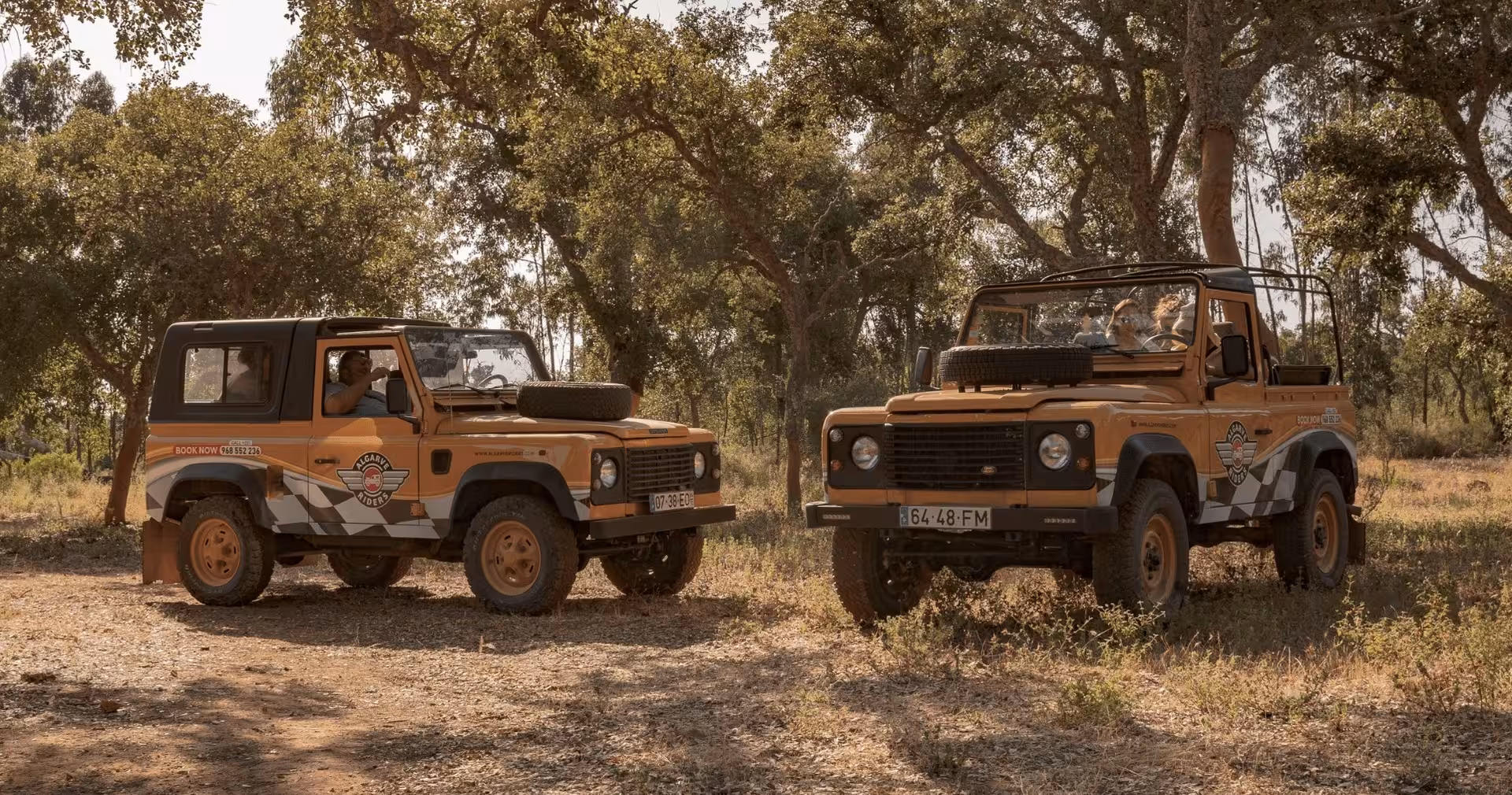Two classic Algarve Riders jeeps stopped in a shady cork oak forest during The Algarve Heritage Journey off-road tour