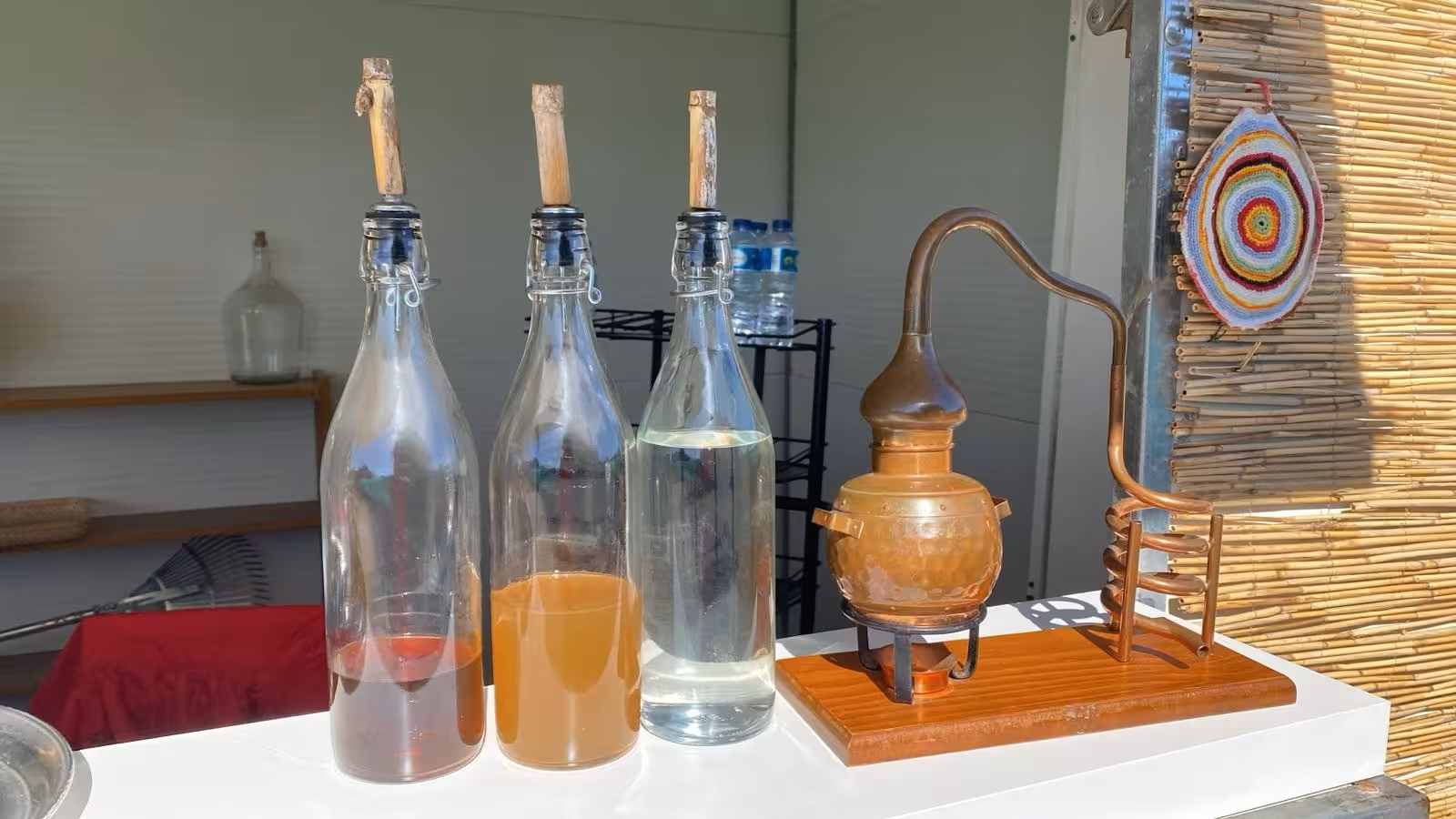 Traditional copper distillery and bottles with local spirits displayed at a countryside stop on Algarve Jeep Safari
