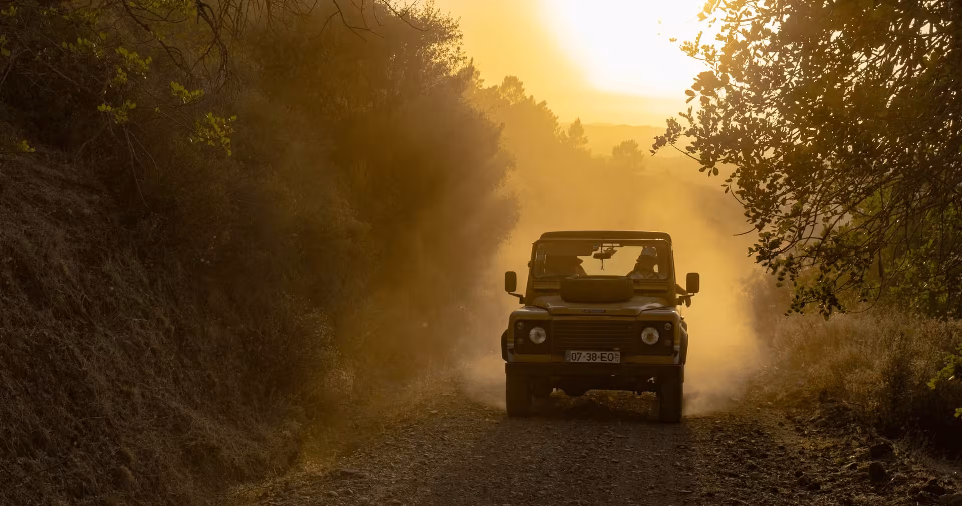 4x4 jeep driving dusty off-road trail through Algarve countryside during a private golden hour safari