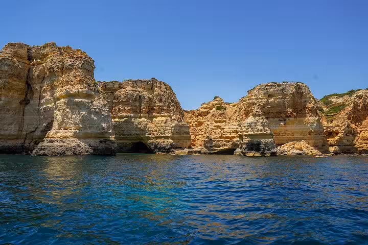 Algarve limestone cliffs and blue Atlantic water, scenic stop on private all-inclusive Lisbon to Algarve tour